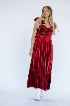 Indulge in luxury and make a statement this holiday season with our Cindy Velvet Dress in stunning red. Wrapped in soft velvet, this maxi dress exudes elegance and is adorned with a delicate bow detail. Dress to impress in this must-have piece for any special occasion. Product Materials: 95% Polyester, 5% Spandex Model Measurements: Hips 36” Waist 25” Bust: 31”, Height 5’5.5, wearing a size small Blessing Dress, Temple Dress, Red Shirt Dress, Boho Style Dresses, Bow Detail Dress, Red Shirt, Bag Dress, Romper Pants, Trending Dresses