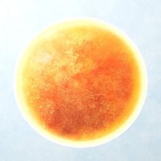 an orange substance is in the middle of a blue sky