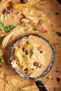 a bowl filled with soup next to a spoon