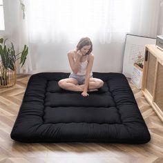 a woman is sitting on an inflatable mattress