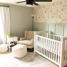 a baby's room with a white crib, chair and ottoman in it