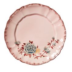 a pink plate with blue and white flowers on the rim, against a white background