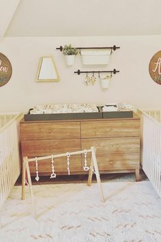 a baby crib in the corner of a room next to a dresser and mirror