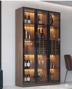 a glass fronted cabinet with bottles and glasses on it