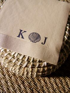 a close up of a napkin on a woven table cloth with the word koi