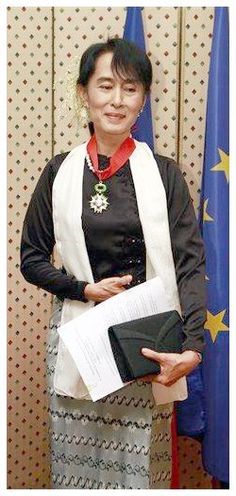 a woman standing in front of flags holding papers