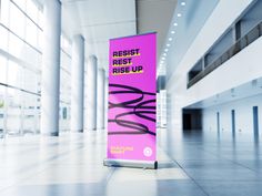 a purple sign in an empty building with white columns and lights on the ceiling is advertising rest rest rise up