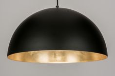 a black and gold pendant light hanging from a ceiling