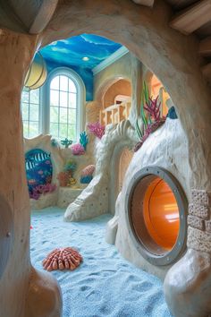 an indoor play area with fake corals, rocks and water features on the walls