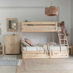 a bedroom with bunk beds and rugs on the floor