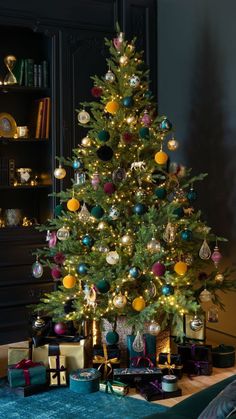 a decorated christmas tree with presents under it