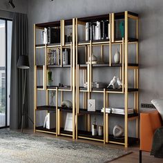 a living room filled with furniture and a book shelf next to a sliding glass door