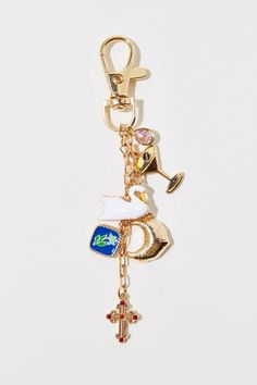 a keychain with charms on it that include an anchor, cross and other items