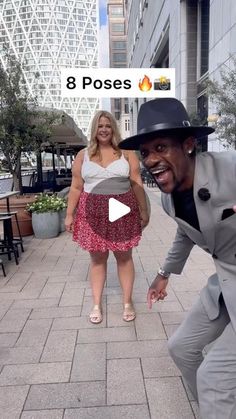 a man in a suit and hat dancing on the sidewalk with a woman behind him