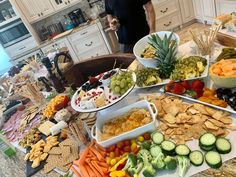 a table filled with lots of different types of food on top of plates and bowls