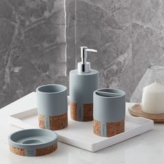 a bathroom set with soap dispenser, toothbrush holder and two cups