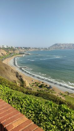 a view of the beach and ocean from an overlook point