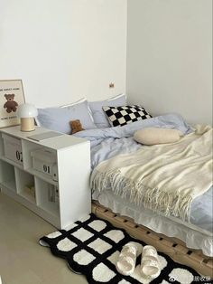 a bedroom with a bed, bookcase and rugs