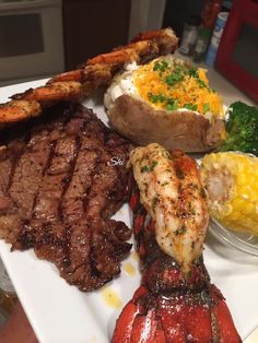 a white plate topped with steak, potatoes and broccoli on top of a table