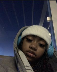 a woman wearing headphones and a hoodie