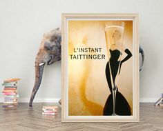 an elephant standing next to a framed poster