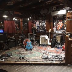 a room filled with guitars and other musical equipment