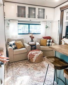 a living room filled with furniture next to a window