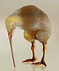 an image of a bird that is bending down with its head in the water and it's long legs sticking out