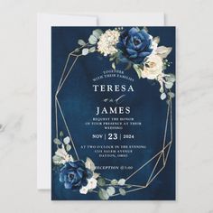 a wedding card with blue flowers and greenery on the front, in gold foil