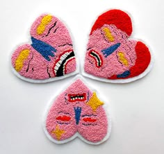 three patches with cartoon characters on them sitting next to each other in the shape of hearts