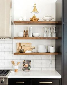 the shelves in this kitchen are filled with dishes