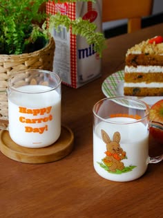 there are two mugs on the table with cake and milk in front of them