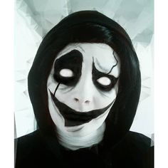 a person with black and white makeup on their face