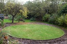 a circular lawn in the middle of a garden