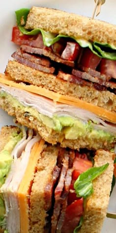 two sandwiches stacked on top of each other with meat and vegetables in the middle one is cut in half