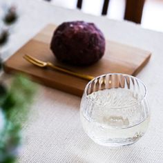 a table with a glass bowl and an object on it