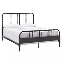 a black metal bed frame with white sheets