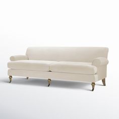 a white couch sitting on top of a wooden floor