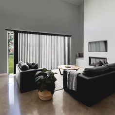 a living room with two couches and a coffee table in front of a sliding glass door