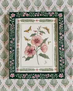 a painting with pink flowers and green leaves on a white wallpapered background is framed in an ornate frame