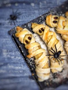 several pastries are arranged on a tray with spider webs in the middle,