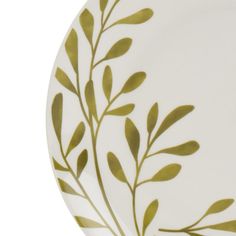 a white plate with green leaves painted on the front and back side, in an elegant manner