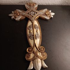 an ornate cross is sitting on a table