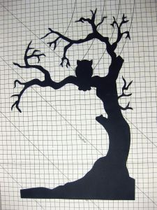 the silhouette of a tree is shown on a piece of paper