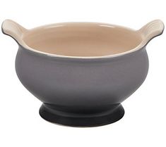 a gray and white bowl sitting on top of a table