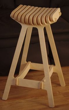 a wooden stool sitting on top of a hard wood floor