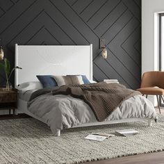 a bedroom with a bed, chair and rug in front of a window that looks out onto the outdoors