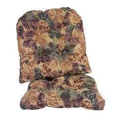 a chair cushion that has been placed on top of each other, with leaves and flowers all over it