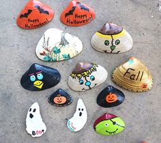 painted rocks with faces and words on them are laid out in the shape of pumpkins