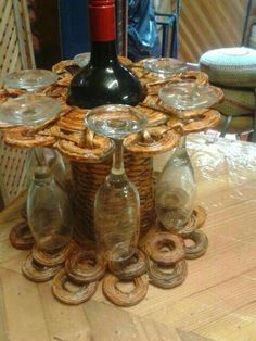 a wine bottle sitting on top of a wooden table next to empty glasses and plates